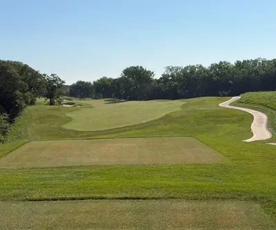 Tee box looking down a fairway toward a green with a curving cart path at Quarry Oaks Golf Club in Ashland, Nebraska