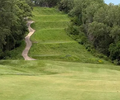Terraced tee boxes stacked up a wooded hillside above the fairway at Quarry Oaks Golf Club in Ashland, Nebraska
