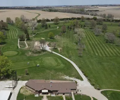 Aerial view of the clubhouse, cart paths and striped fairways at Falls City Golf Course in Falls City, Nebraska