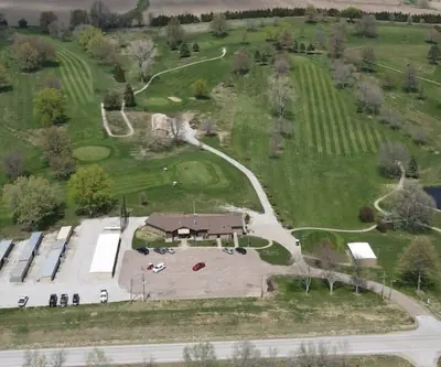 Aerial view of the clubhouse, cart sheds, parking lot and two ponds at Falls City Golf Course in Falls City, Nebraska