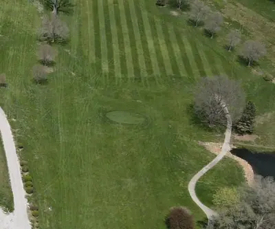 Overhead aerial of a striped fairway and winding cart path at Falls City Golf Course in Falls City, Nebraska