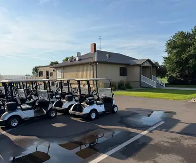 Row of golf carts parked outside the clubhouse at Southern Hills Golf Club in Hastings, Nebraska