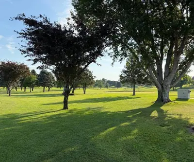 Mature shade trees casting long shadows across a fairway at Southern Hills Golf Club in Hastings, Nebraska
