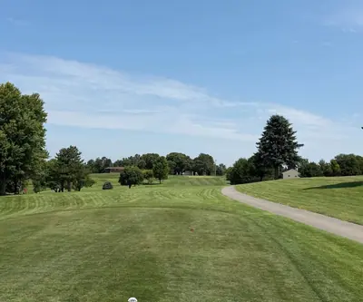 Striped tee box looking down a tree-lined fairway beside a cart path at Southern Hills Golf Club in Hastings, Nebraska