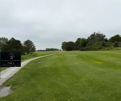 Hole 2 par 4 sign beside a cart path and fairway at The Greens At Prairie Hills in Pleasanton, Nebraska