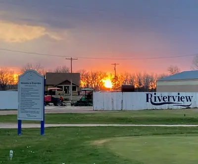 Sunset behind the Welcome to Riverview sign and fence at Riverview Golf Course in Scottsbluff, Nebraska