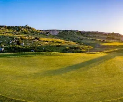 Sunset panorama of a green below rocky bluffs at Hillside Golf Course in Sidney, Nebraska